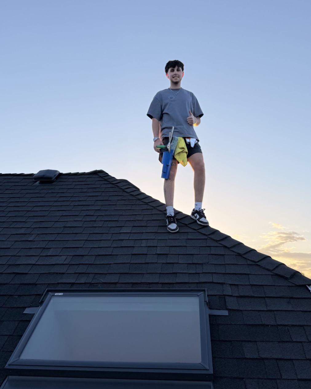 Blake on a roof after a window cleaning job