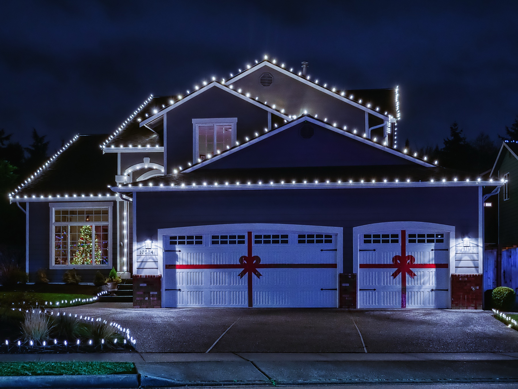 Christmas lights installed on a home at night