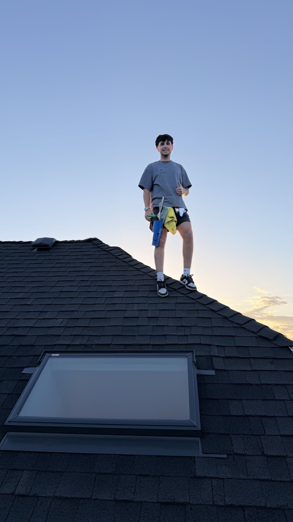 Luxury and Shine crew member on a Spokane rooftop after window cleaning